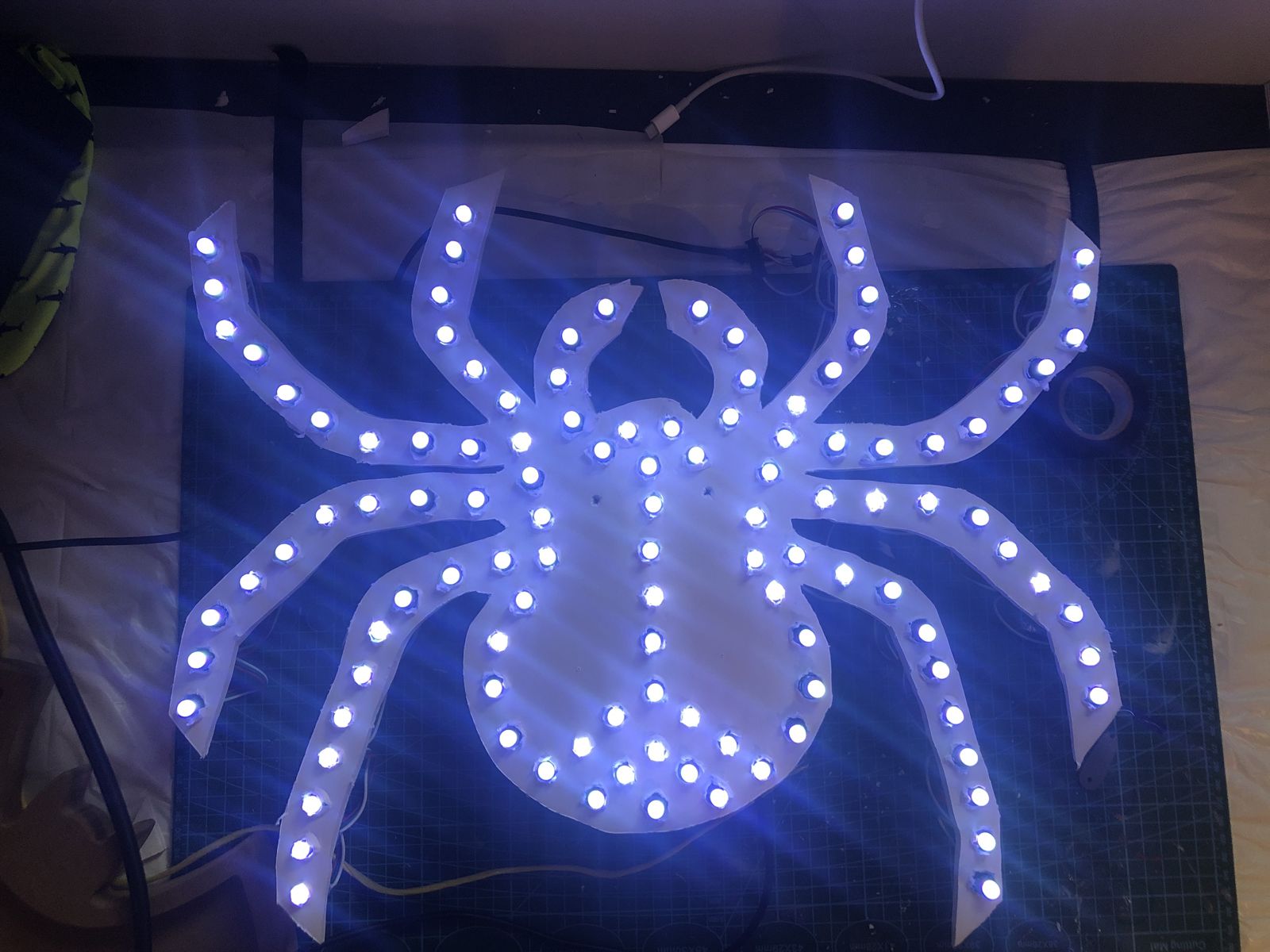 The finished spider prop lit up in white pixels