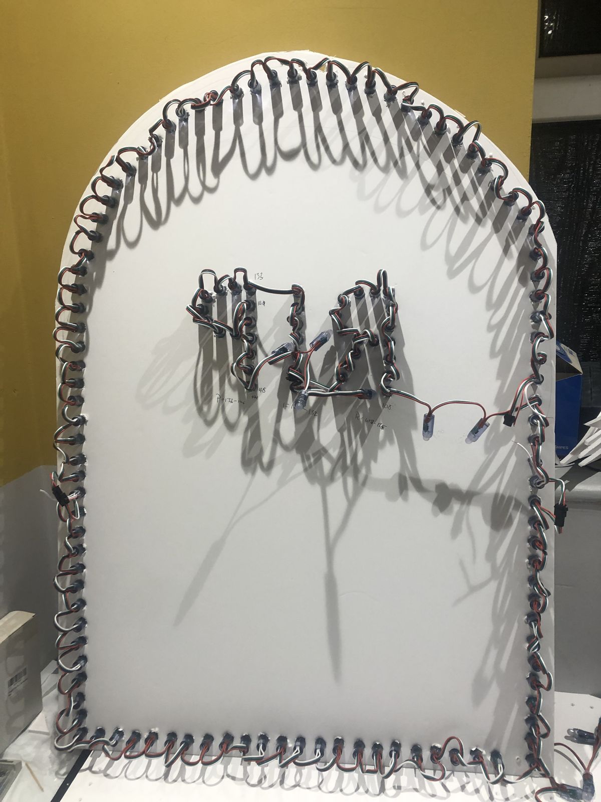 The back of the tombstone showing the pixel string looped around the edge and through the letters